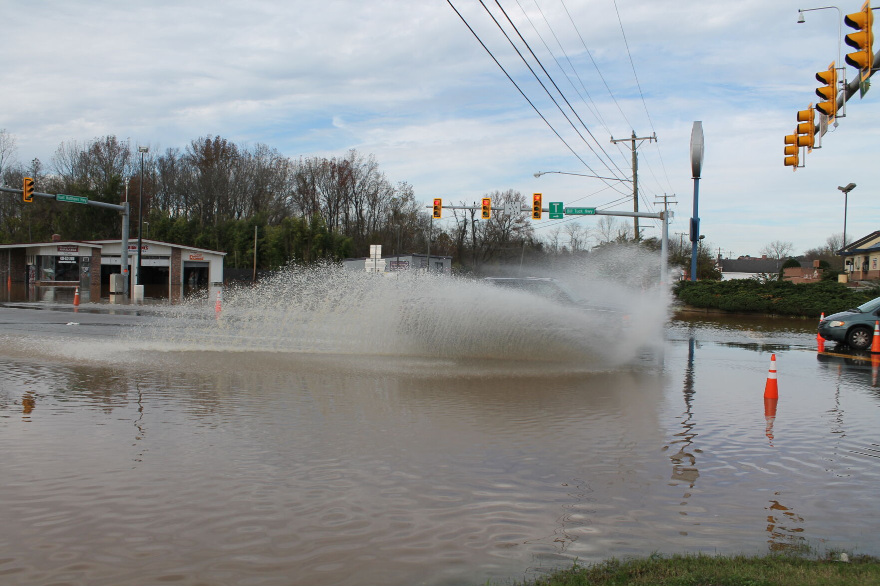 Motorist drive through flood waters at the 501-58 intersection Saturday.JPG
